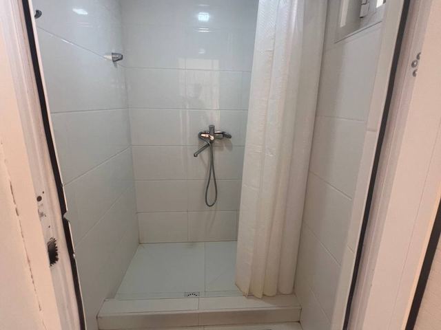 A clean tiled shower cubicle in the camp shower block